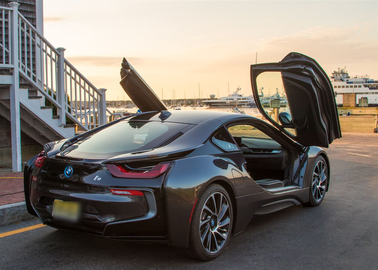 BMW i8 with doors up at Nantucket harbor, deep gloss at sunset