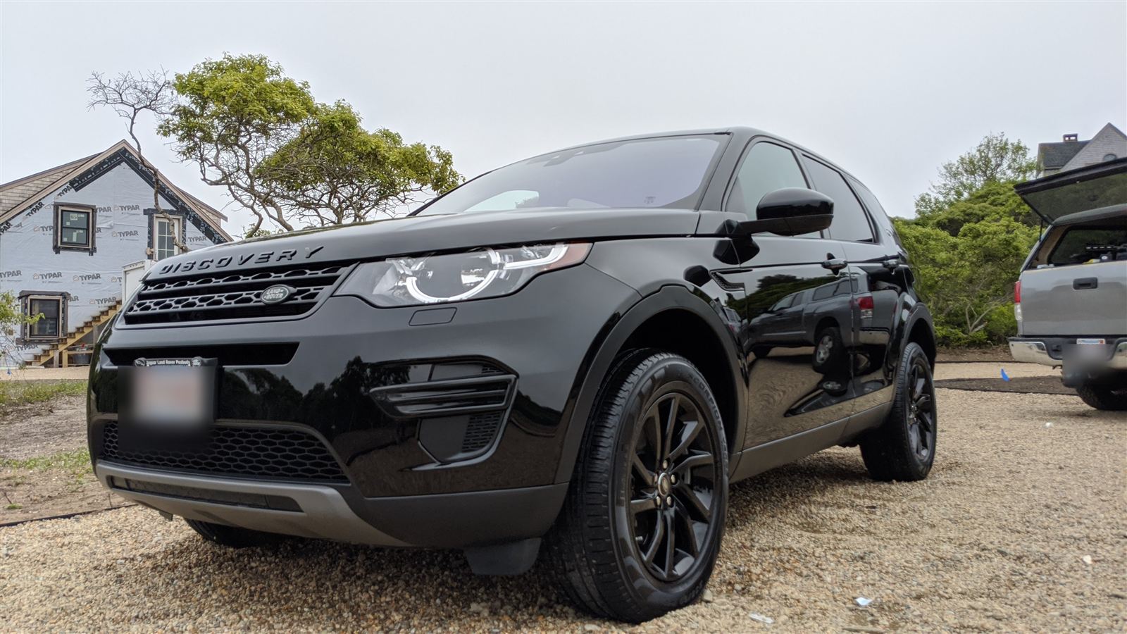 Freshly detailed black Land Rover Discovery Sport gleaming on Nantucket