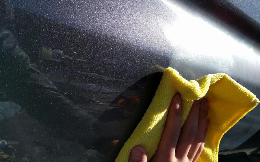 Metallic paint glowing in the sun during the final wipe-down after a polish